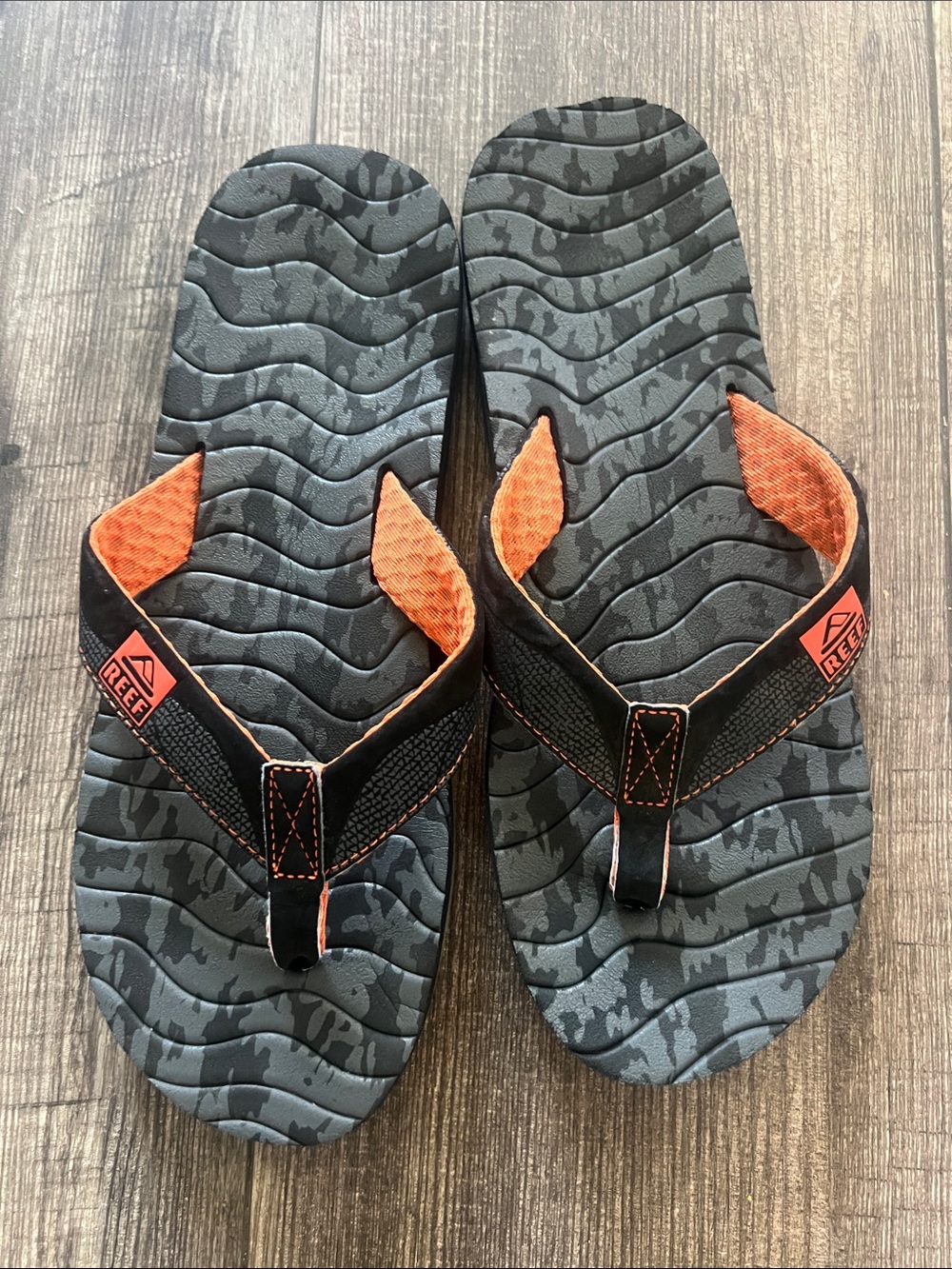 Reef Roundhouse Flip Flops in orange and black